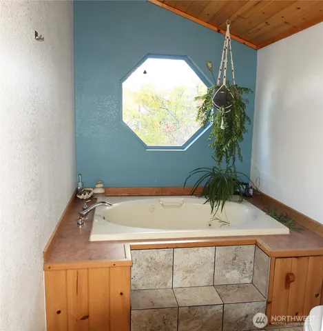 a bathroom with a tub and a sink