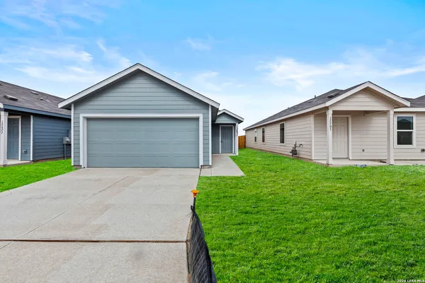 a front view of house with yard and green space