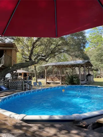 a view of a swimming pool with a yard