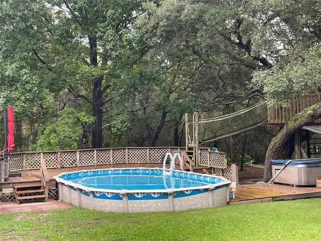 a small pool with some trees and plants