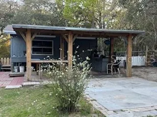 a house view with a sitting space and garden