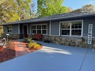 a front view of a house with a yard and porch