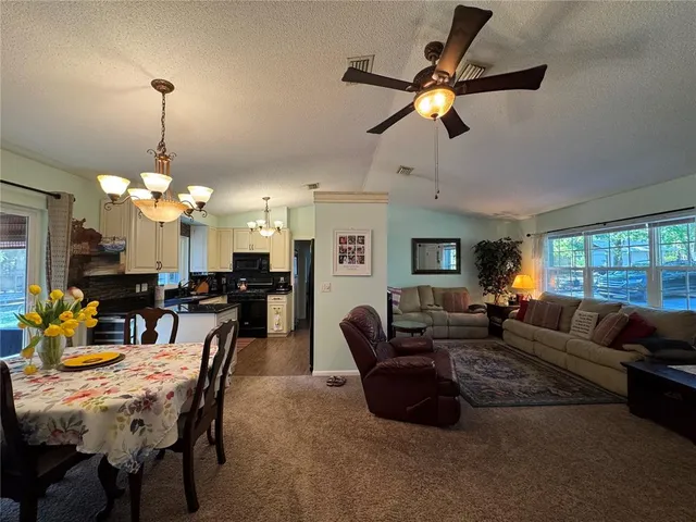 a living room with furniture a chandelier and a chandelier