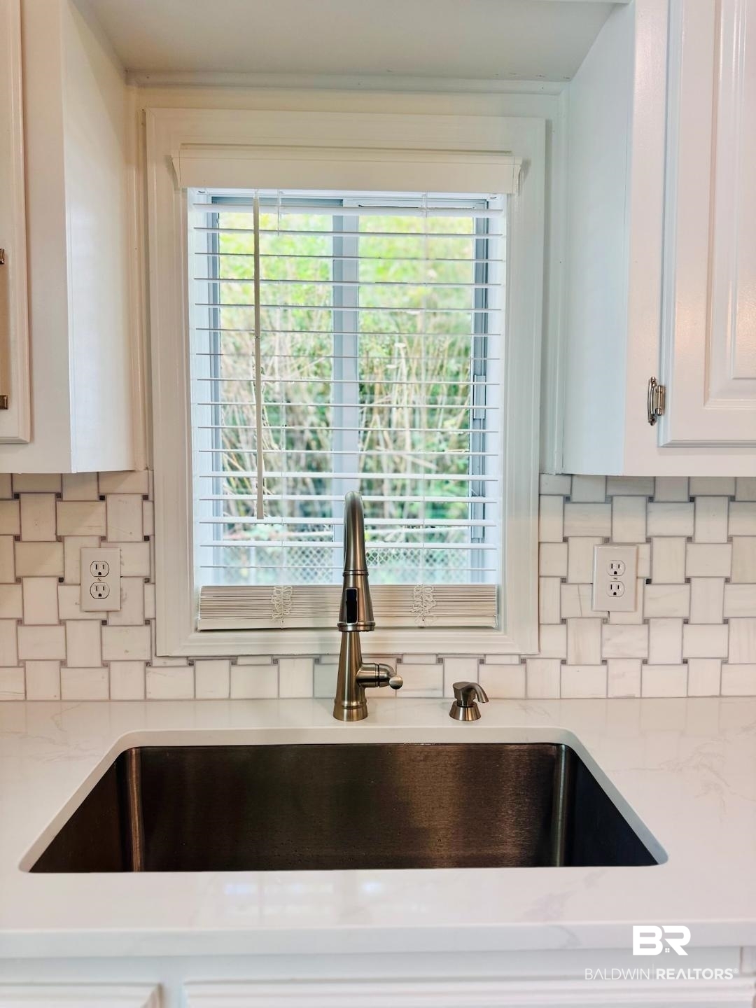 2663 Demetropolis Road Mobile, AL 36693 - Photo 12 of 26 Kitchen view of tasteful backsplash, light stone countertops, and white cabinets