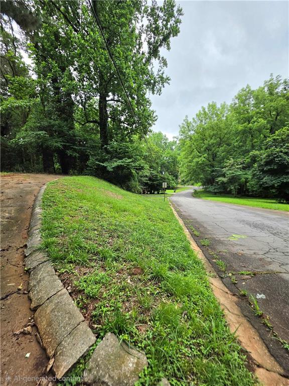 618 Simone Way Stone Mountain, GA 30087 - Photo 4 of 11 a view of a yard with plants and a large tree