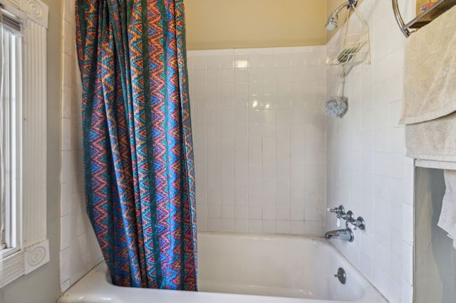 a bathroom with a shower curtain and a bathtub