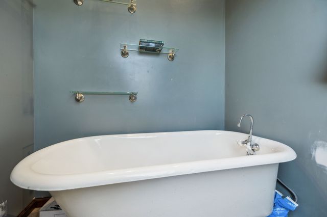 a white bath tub sitting in a bathroom