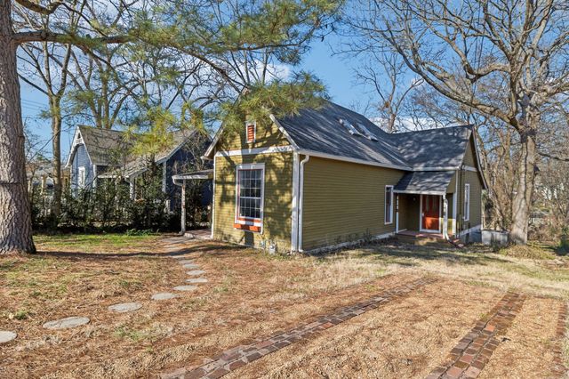 a view of a house with a yard covered with snow