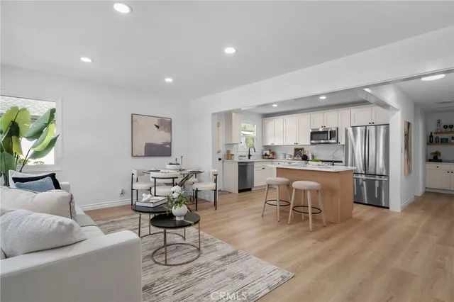 a living room with furniture and kitchen view