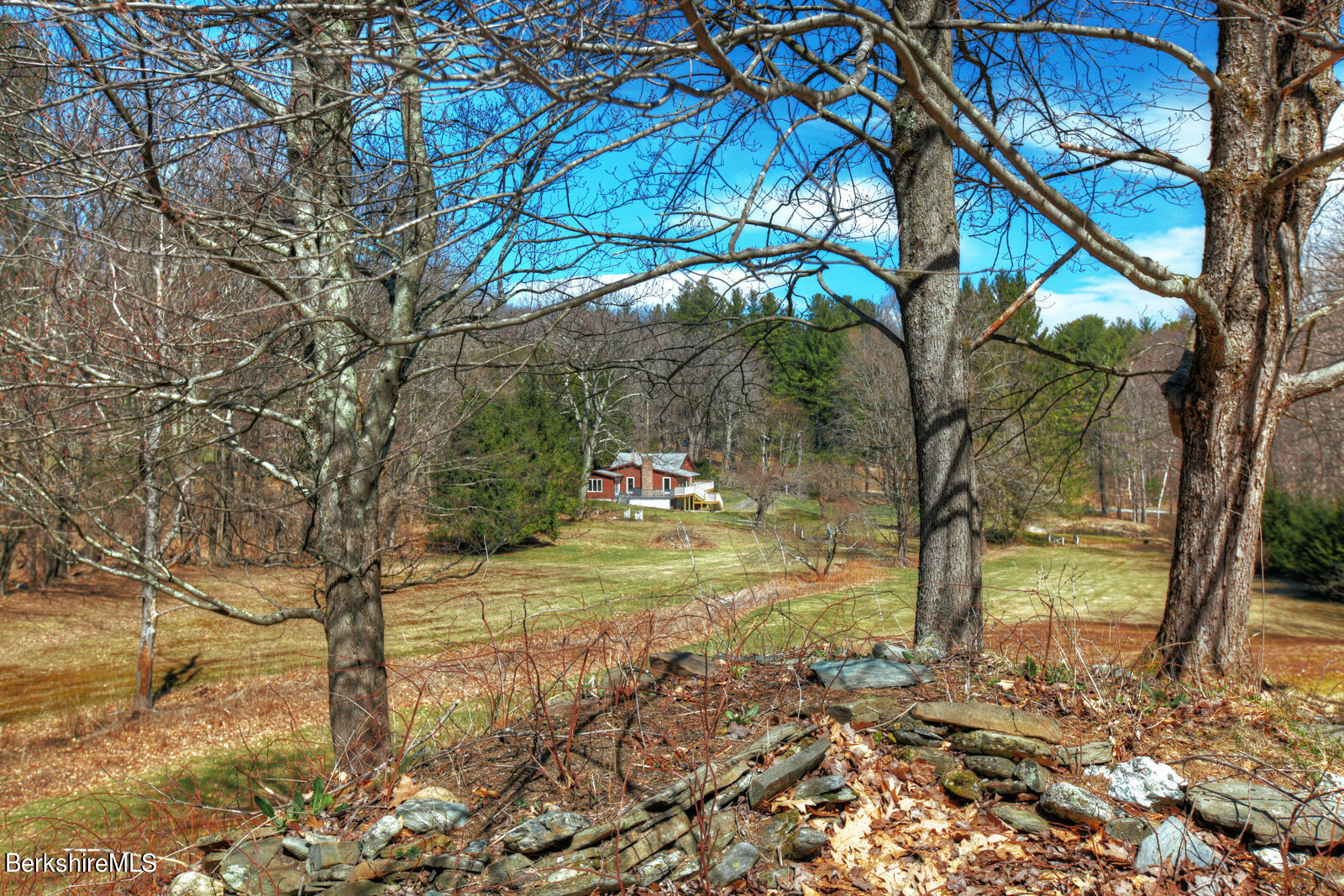 42 Rhoen Road Austerlitz, NY 12017 - Photo 5 of 43 a backyard of a house with table and chairs under an umbrella