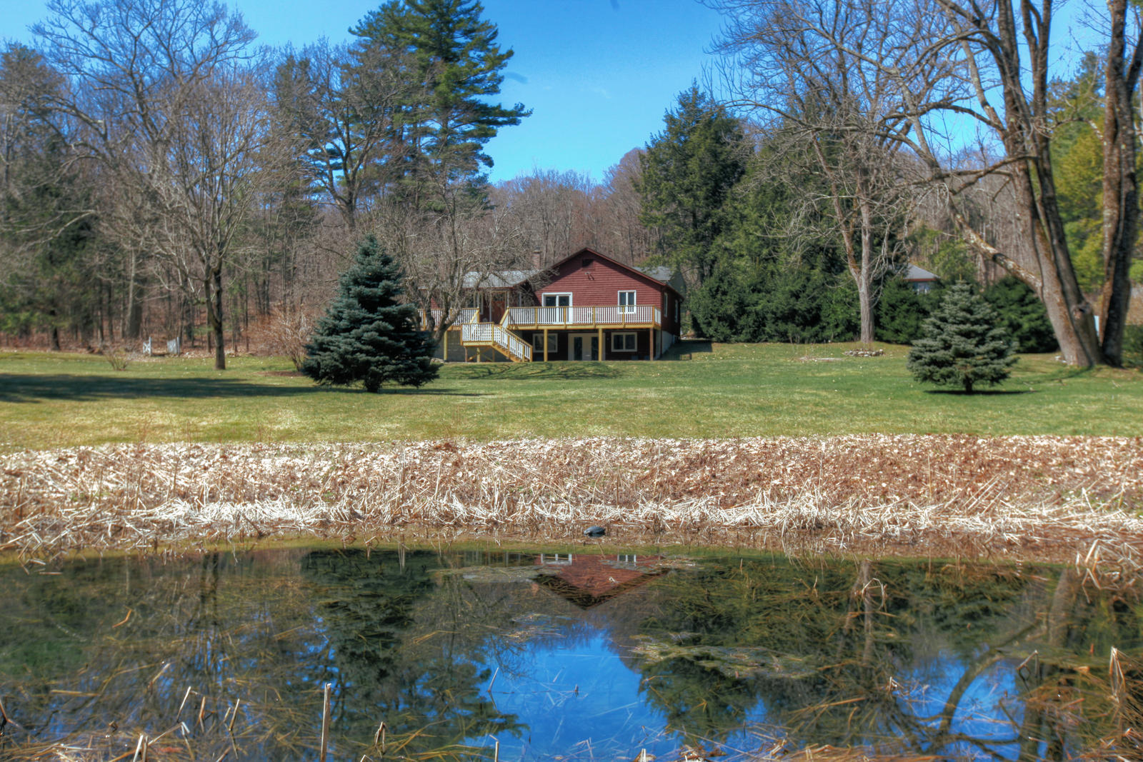 42 Rhoen Road Austerlitz, NY 12017 - Photo 7 of 43 a front view of a house with a yard and large trees