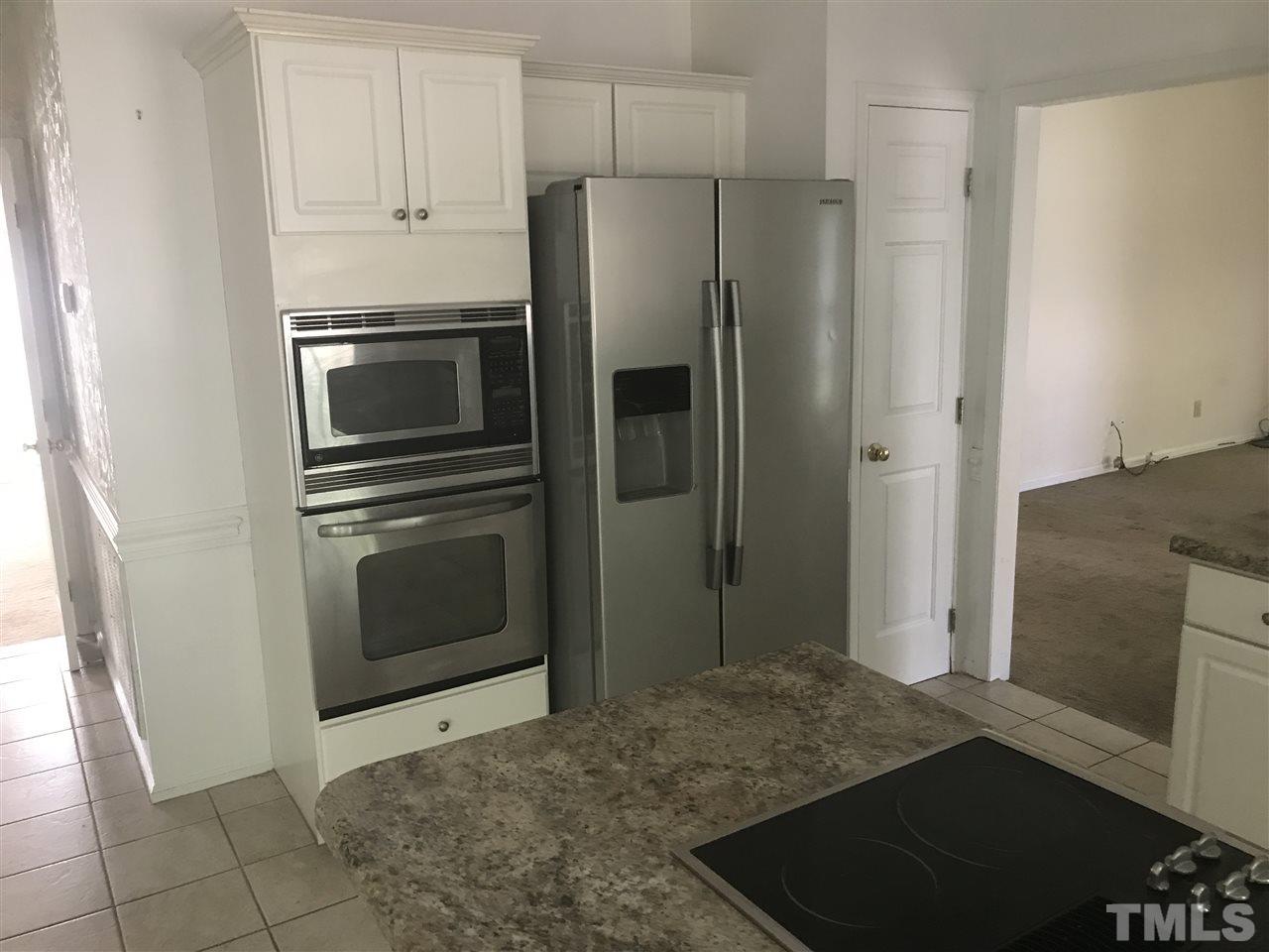3205 Coppedge Lane Raleigh, NC 27616 - Photo 11 of 20 a kitchen with stainless steel appliances a refrigerator and a stove