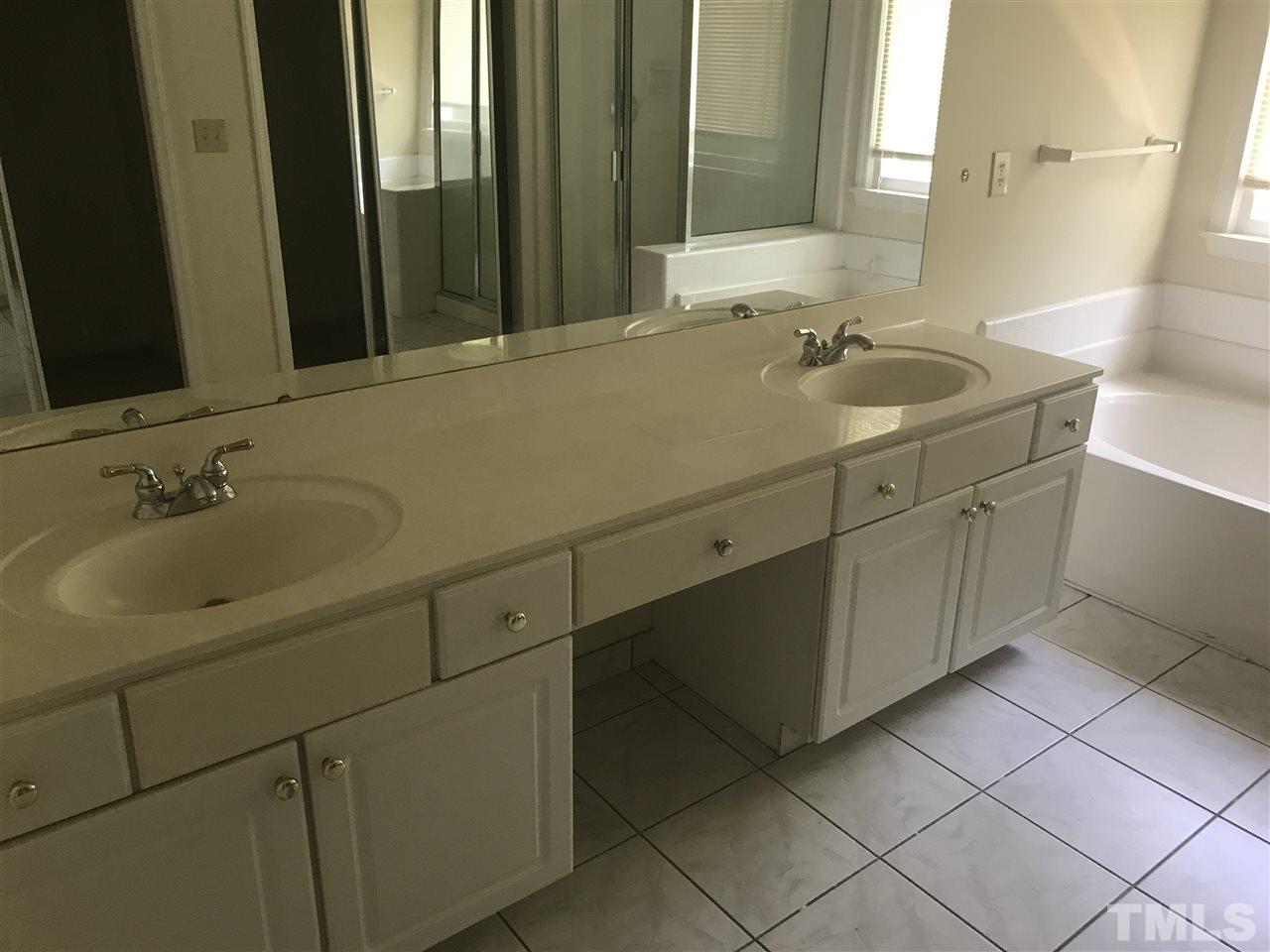 3205 Coppedge Lane Raleigh, NC 27616 - Photo 14 of 20 a bathroom with a sink and a mirror