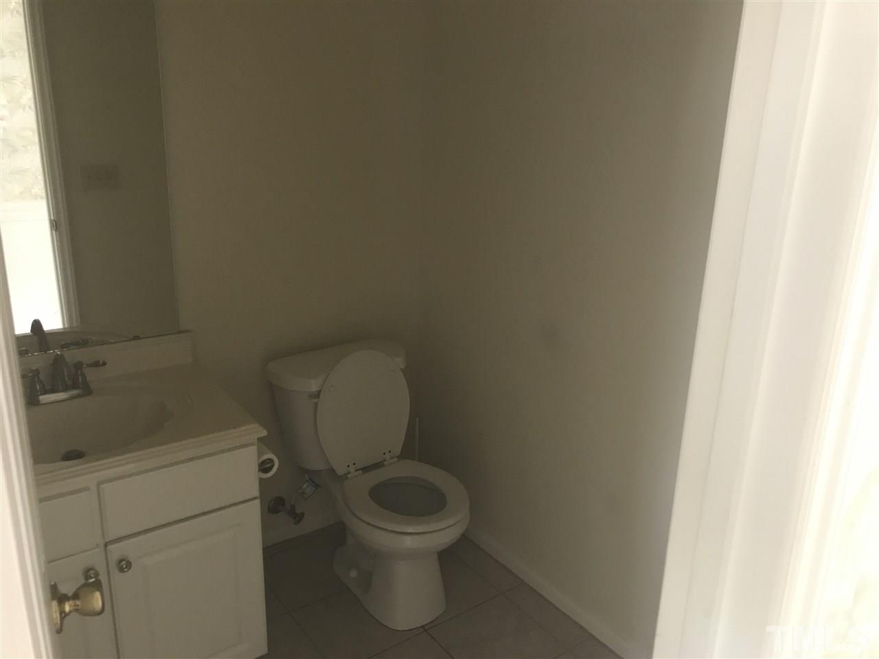 3205 Coppedge Lane Raleigh, NC 27616 - Photo 7 of 20 a white toilet sitting next to a sink