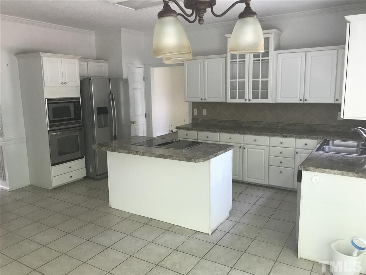 3205 Coppedge Lane Raleigh, NC 27616 - Photo 8 of 20 a kitchen with a stove a sink and a refrigerator