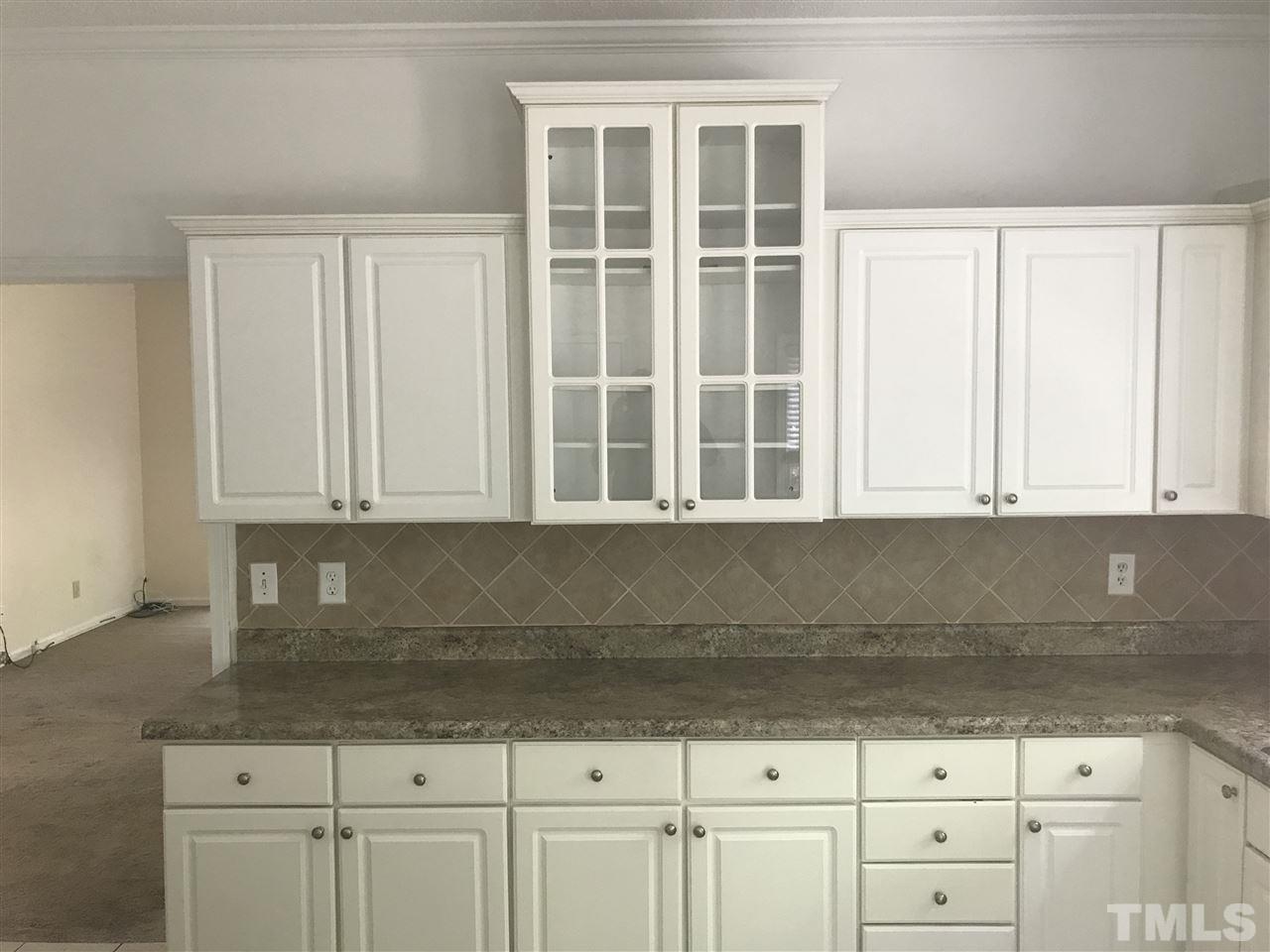 3205 Coppedge Lane Raleigh, NC 27616 - Photo 10 of 20 a kitchen with granite countertop white cabinets and sink