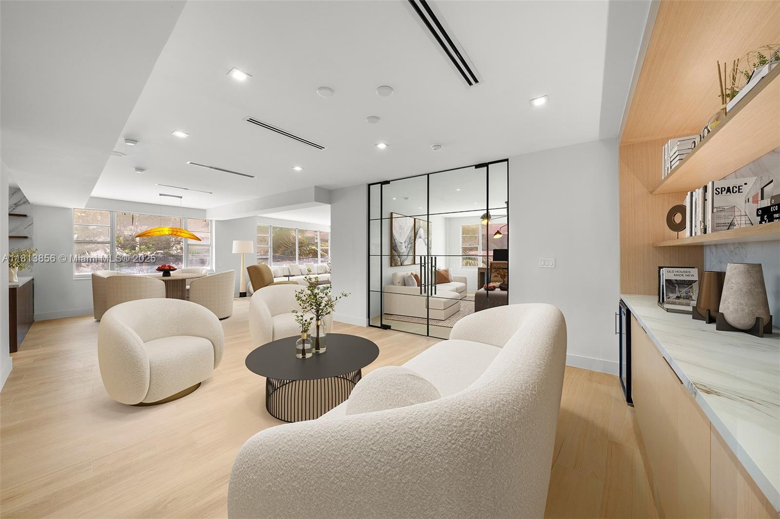 a living room with furniture and kitchen view