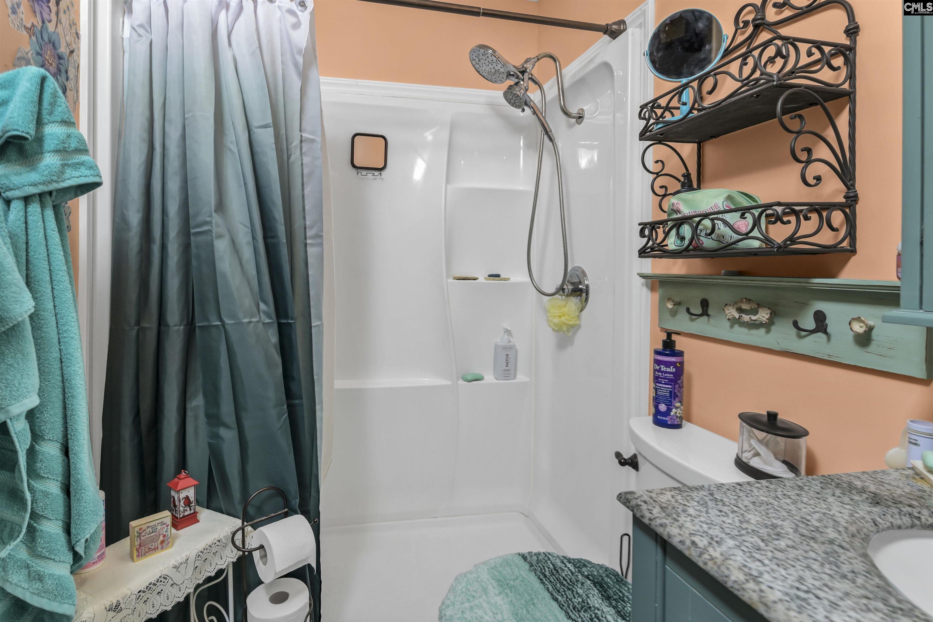 133 Sunset Strip Elgin, SC 29045 - Photo 19 of 30 a bathroom with a granite countertop sink and a mirror