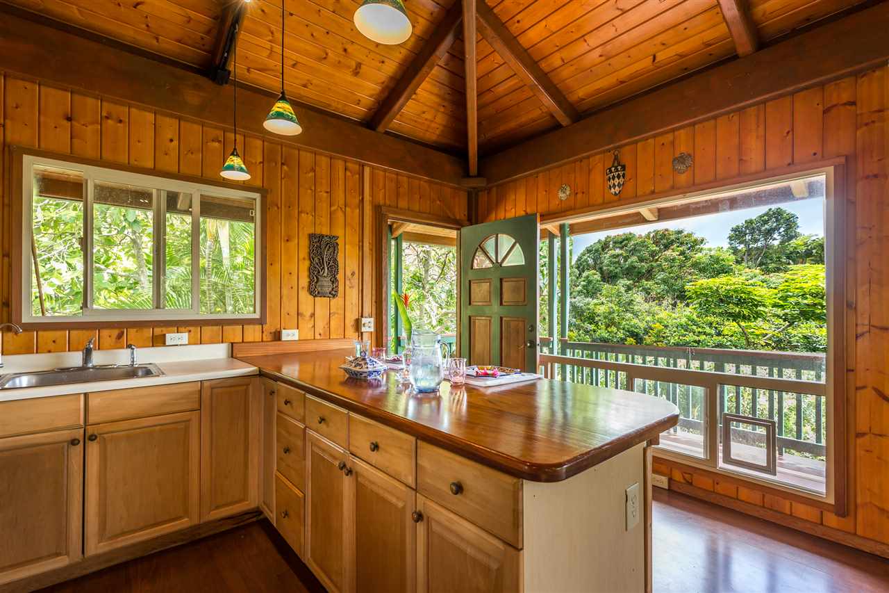 73 Door Of Faith Road Haiku, HI 96708 - Photo 4 of 30 a kitchen with a sink and wooden cabinets
