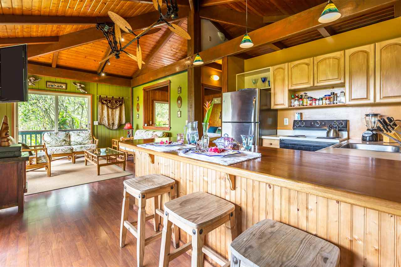 73 Door Of Faith Road Haiku, HI 96708 - Photo 10 of 30 a dining hall with stainless steel appliances granite countertop a stove and cabinets with wooden floor