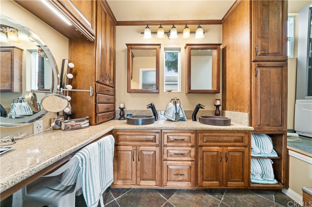 4909 El Molino Avenue Riverside, CA 92504 - Photo 12 of 33 a bathroom with a granite countertop sink and a mirror