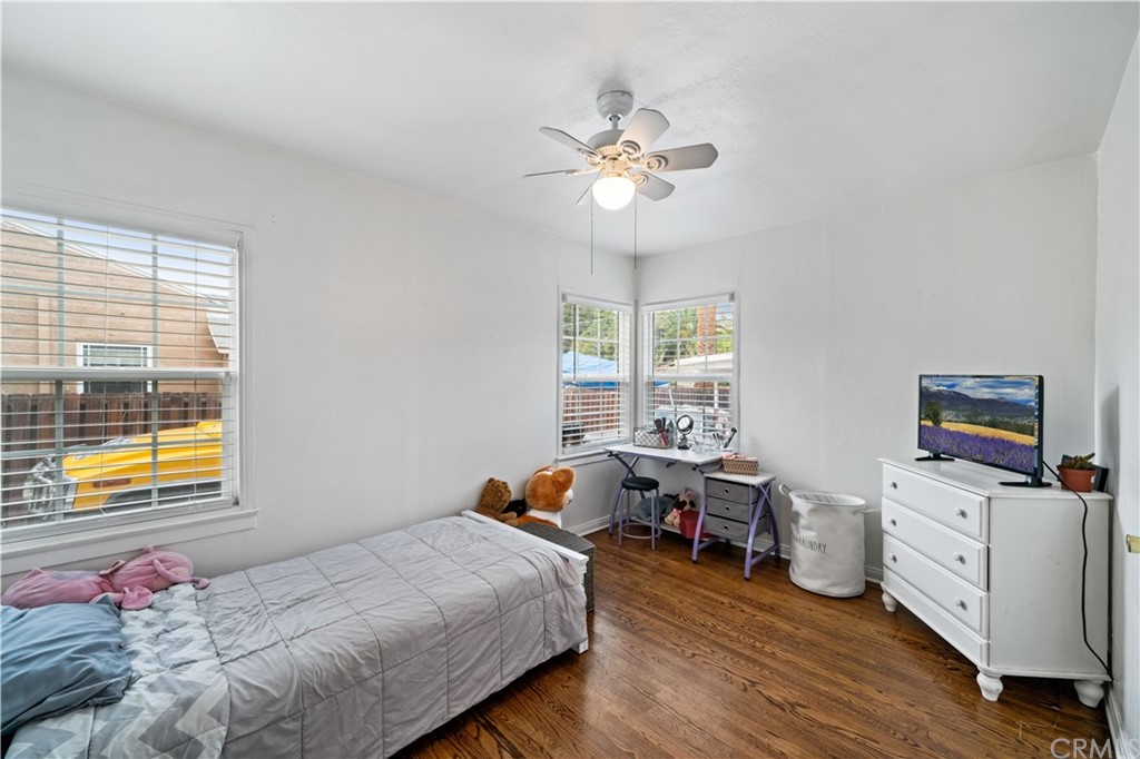 4909 El Molino Avenue Riverside, CA 92504 - Photo 15 of 33 a bedroom with a bed and wooden floor