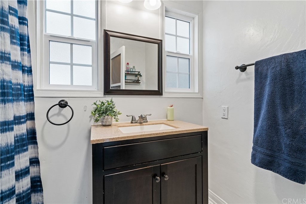 4909 El Molino Avenue Riverside, CA 92504 - Photo 16 of 33 a bathroom with a sink and a mirror