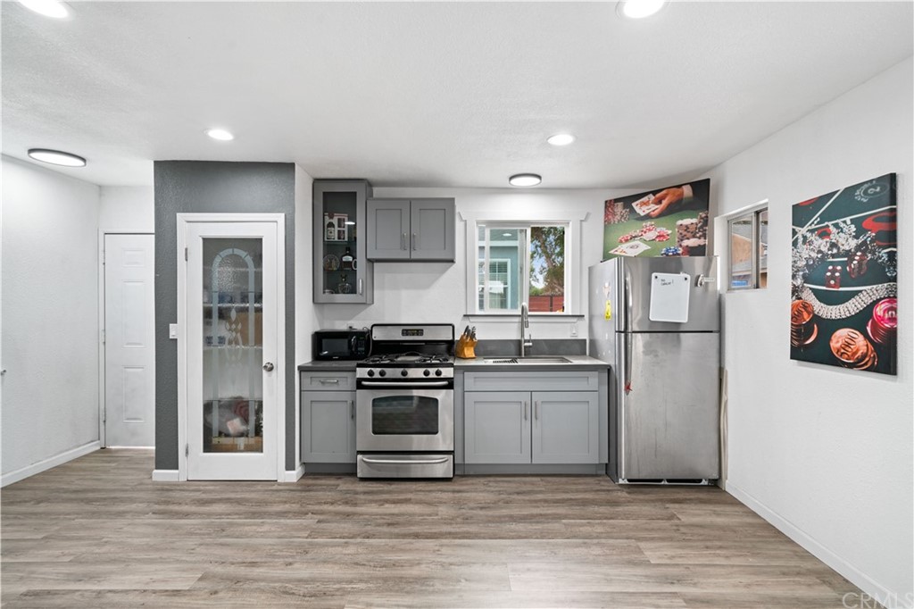4909 El Molino Avenue Riverside, CA 92504 - Photo 21 of 33 a kitchen with stainless steel appliances granite countertop a refrigerator and a stove top oven