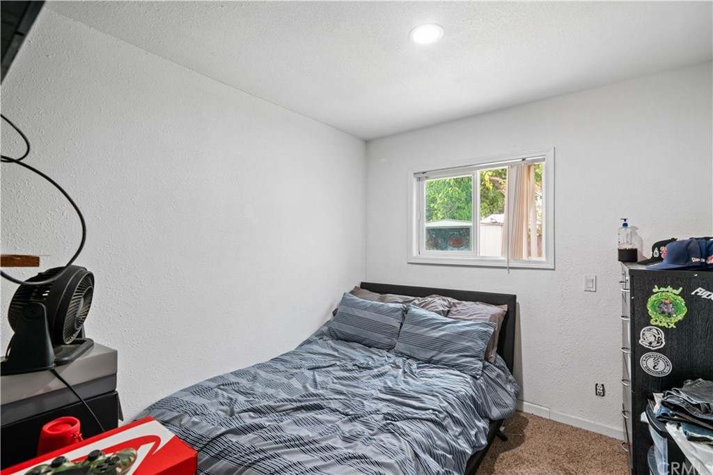 4909 El Molino Avenue Riverside, CA 92504 - Photo 22 of 33 a bedroom with a bed a window and walk in closet