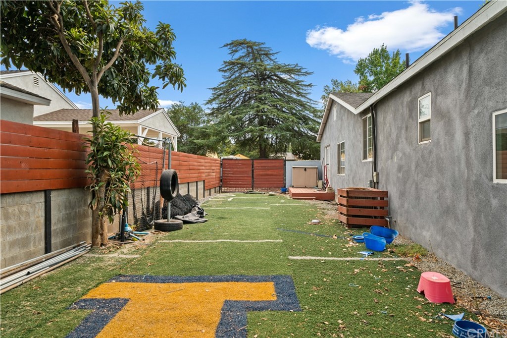 4909 El Molino Avenue Riverside, CA 92504 - Photo 29 of 33 a backyard of a house with barbeque oven table and chairs