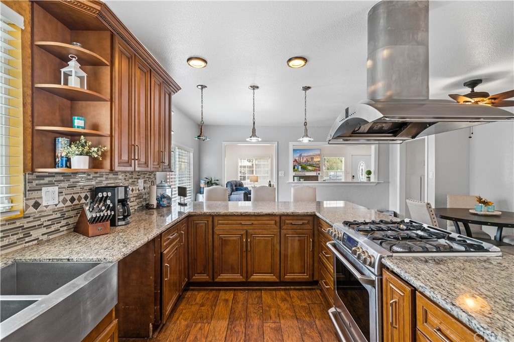 4909 El Molino Avenue Riverside, CA 92504 - Photo 5 of 33 a kitchen with a sink a stove and cabinets