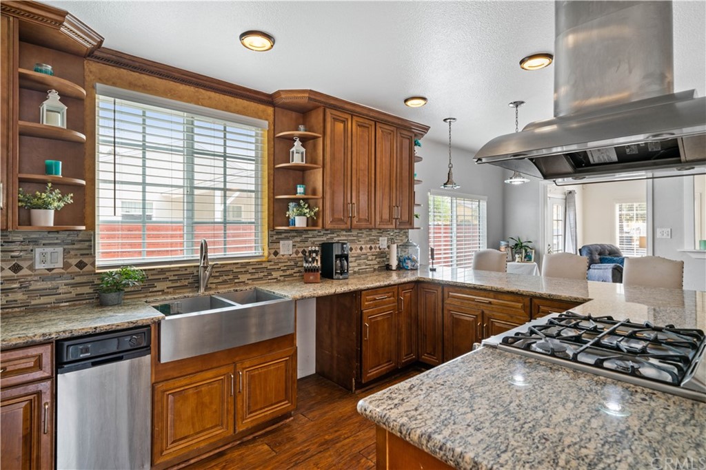 4909 El Molino Avenue Riverside, CA 92504 - Photo 8 of 33 a kitchen with stainless steel appliances granite countertop a sink stove and refrigerator