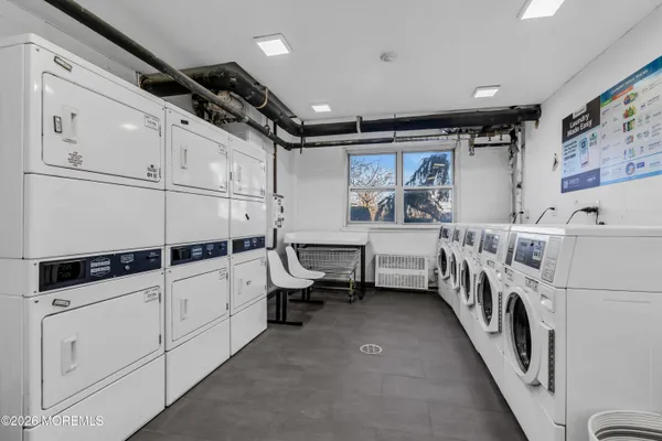 a utility room with multiple dryer and washer