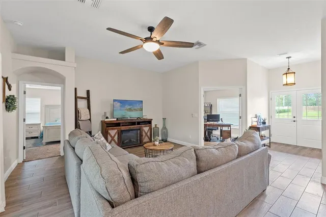a living room with furniture and a wooden floor