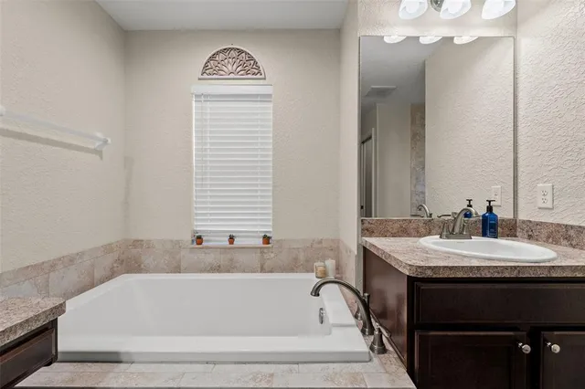 a bathroom with a bathtub and a sink