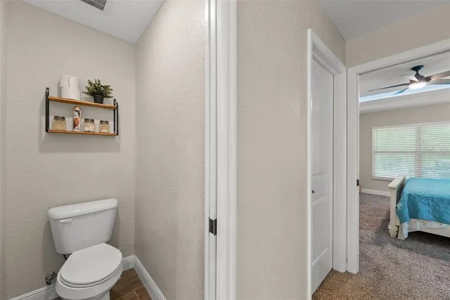 a white toilet sitting next to a bathroom sink