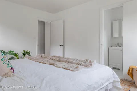 a bedroom with a bed and hallway