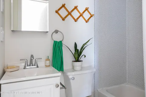 a bathroom with a sink a mirror and vanity