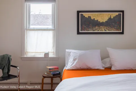 a bedroom with a bed and a window