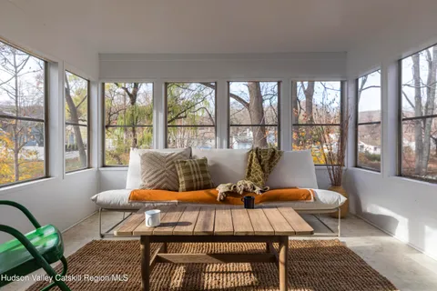a living room with furniture and a floor to ceiling window