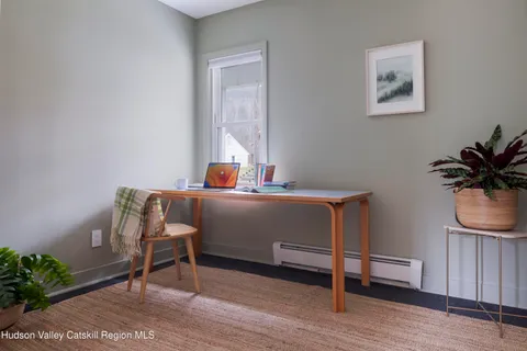 a living room with furniture and a potted plant