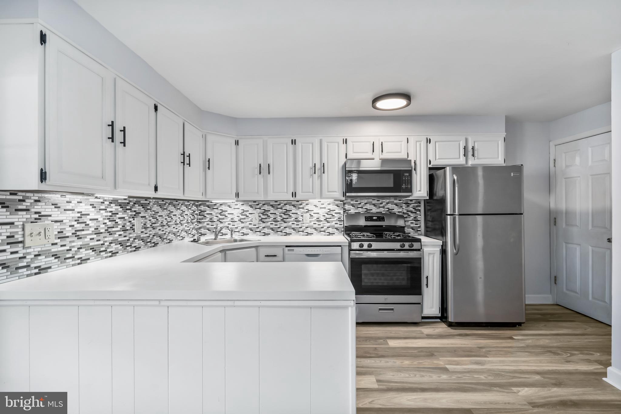 8136 Mid Haven Road Dundalk, MD 21222 - Photo 8 of 29 Tiled Backsplash and Lots of Cabinets