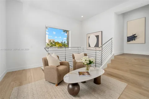 a living room with furniture and painting on the wall