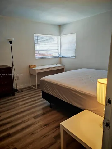 a bedroom with bed and a window