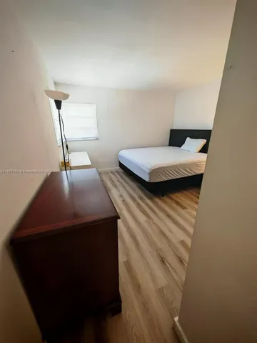 a bedroom with a bed and a desk