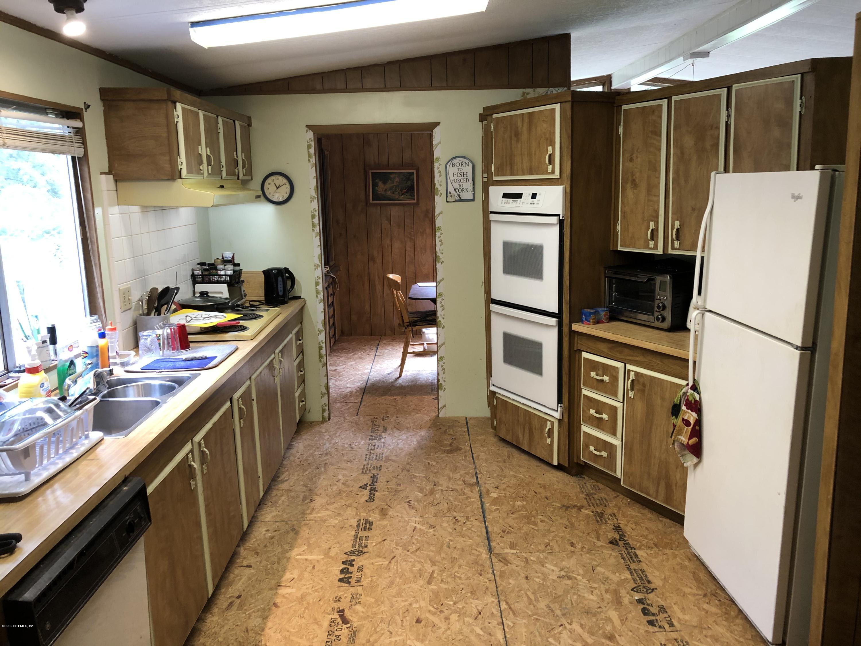 3241 Stanley Drive St. Augustine, FL 32092 - Photo 4 of 8 a kitchen with stainless steel appliances a refrigerator and a stove