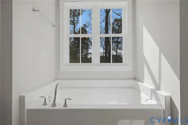 a bathroom with a tub shower and sink