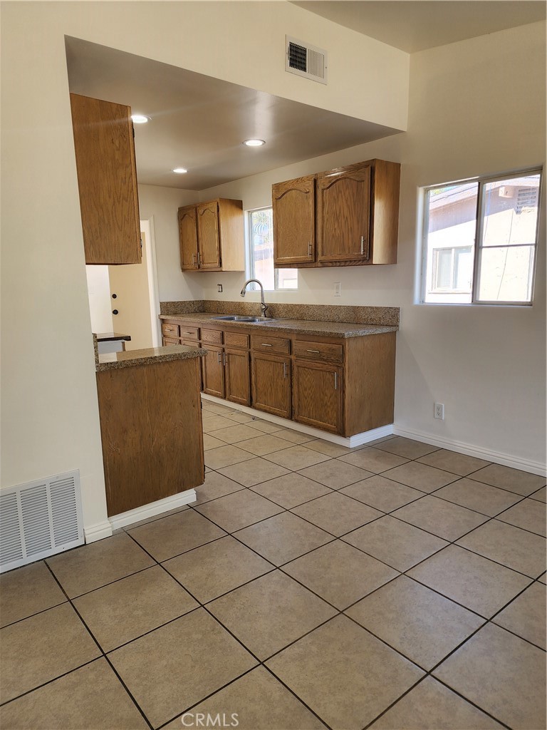 38850 Carolside Avenue Palmdale, CA 93550 - Photo 5 of 10 a kitchen with stainless steel appliances granite countertop a refrigerator and a stove top oven
