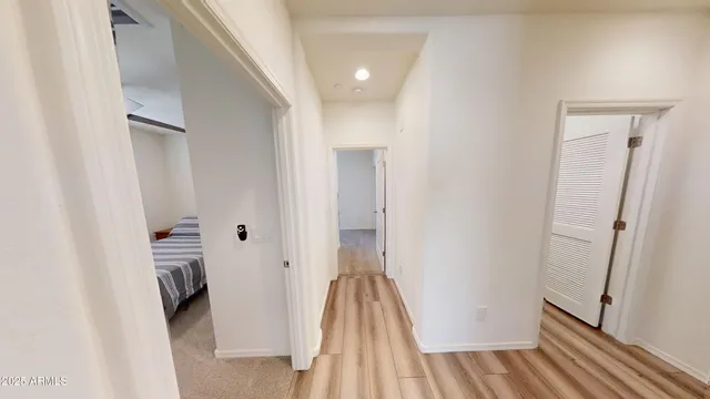 a spacious bedroom with a large bed and a chandelier