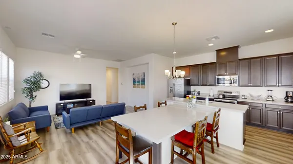 a kitchen with refrigerator cabinets and wooden floor